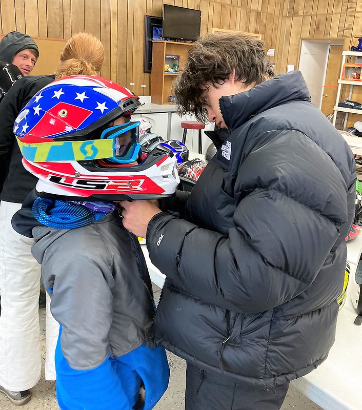 two kids getting ready for a snowmobile tour