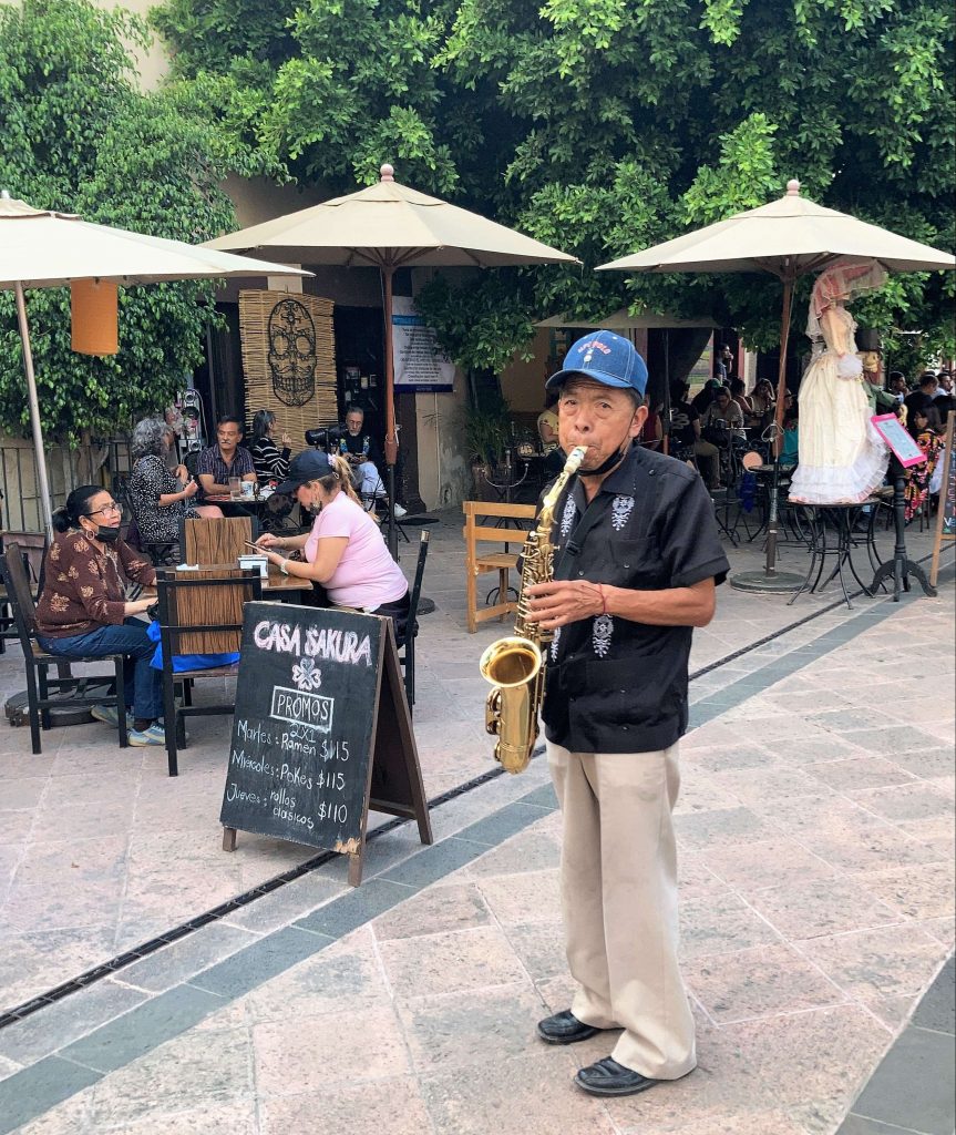 old man playing a saxo in queretaro, mexico