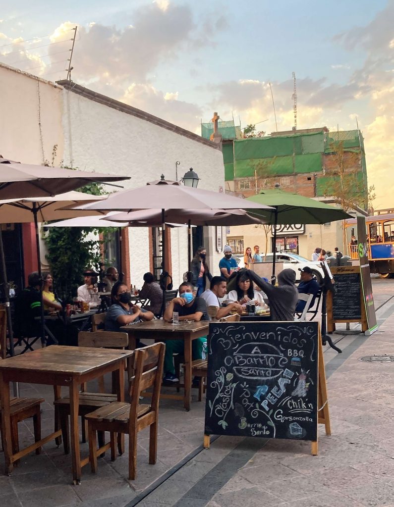 people sitting outside a cafe in queretaro historic center