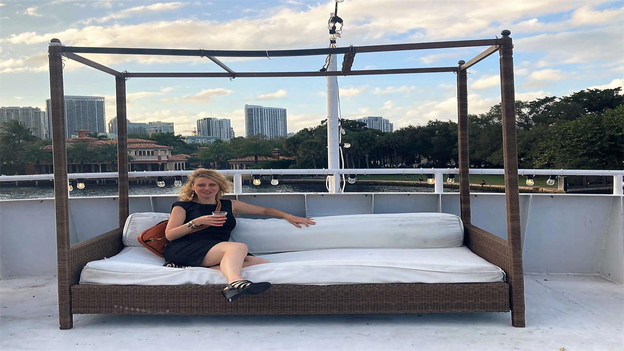 Woman sitting on a lounge bed on a rented yacht in ft lauderdale