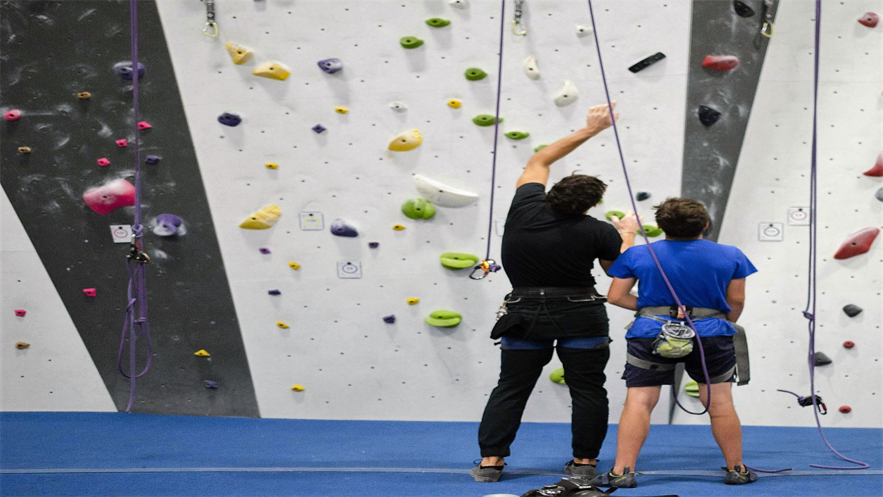 two guys at a indoor climbing gym