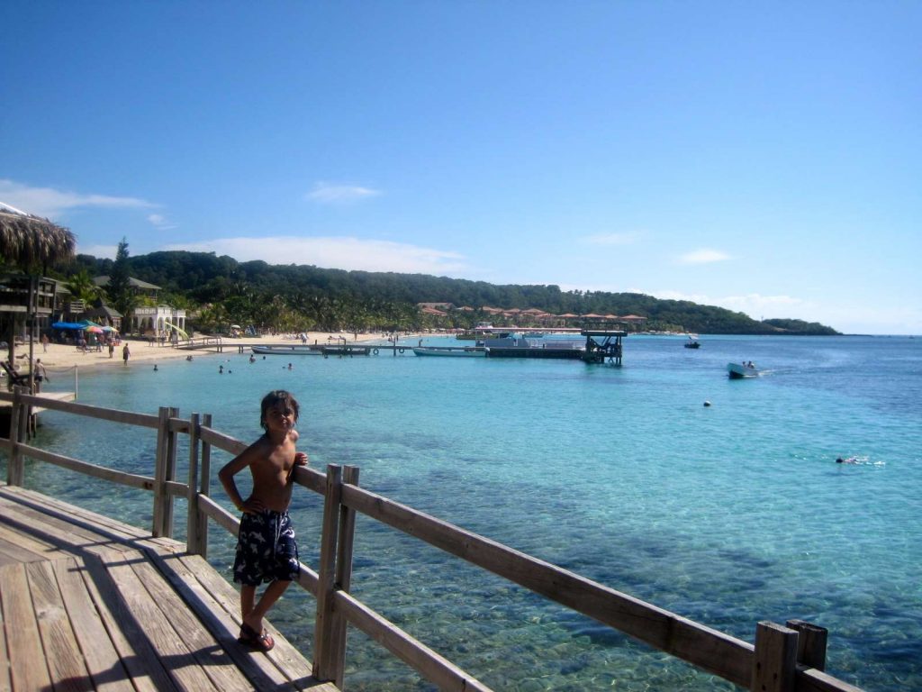 a kid on a dock in roatan bay island honduras