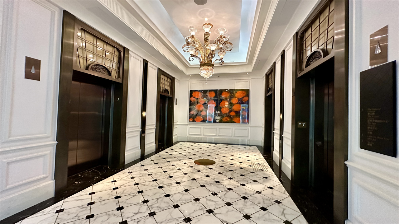 a hallway with black and white flooring and chandelier at the Mandarin Oriental Taipei