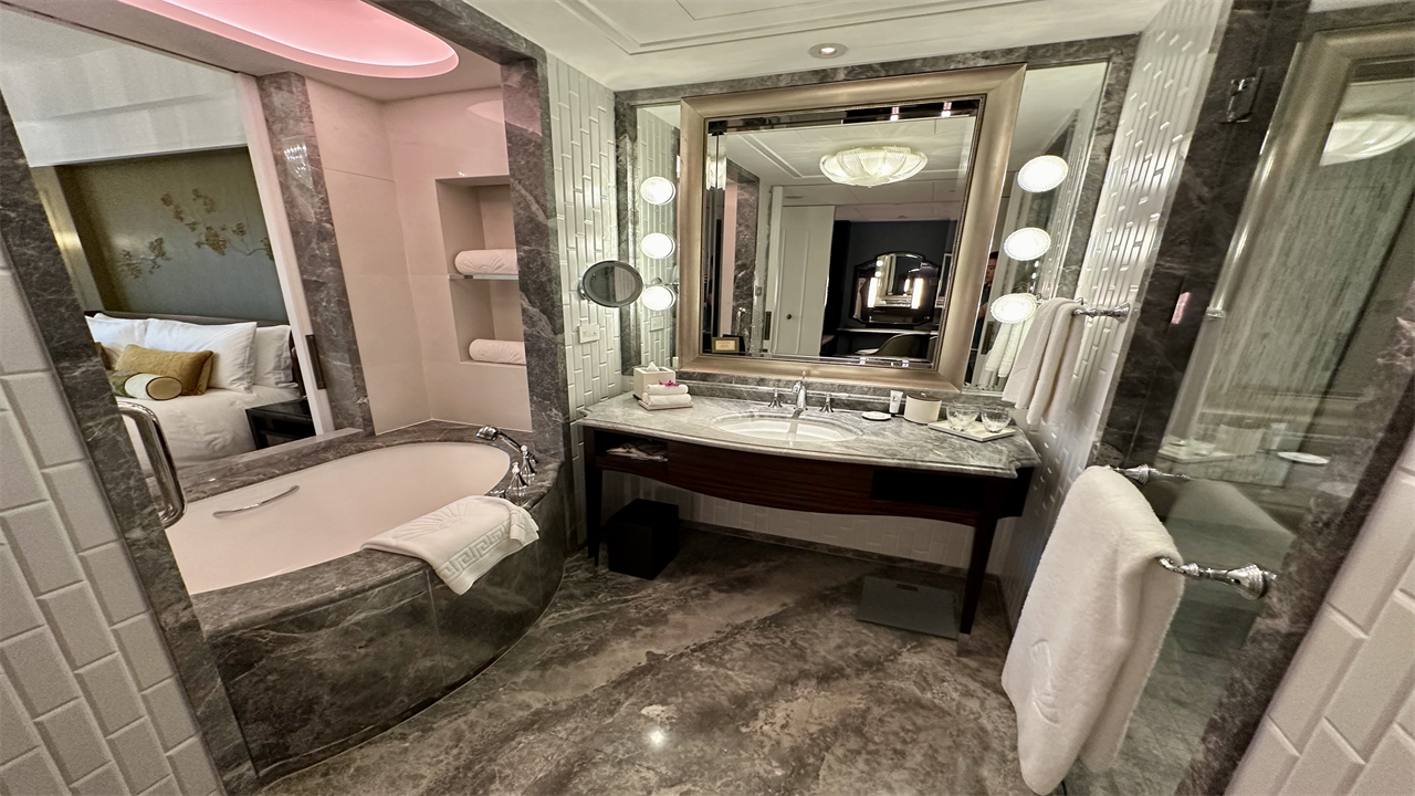 a bathroom with a tub and a mirror at the Mandarin Oriental Taipei