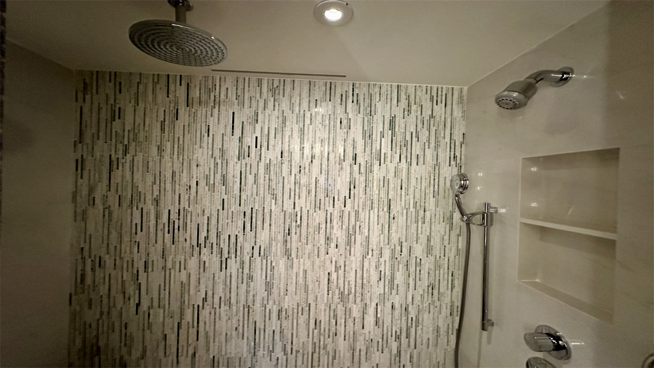 a shower with a white wall and a white shelf at the Mandarin Oriental Taipei