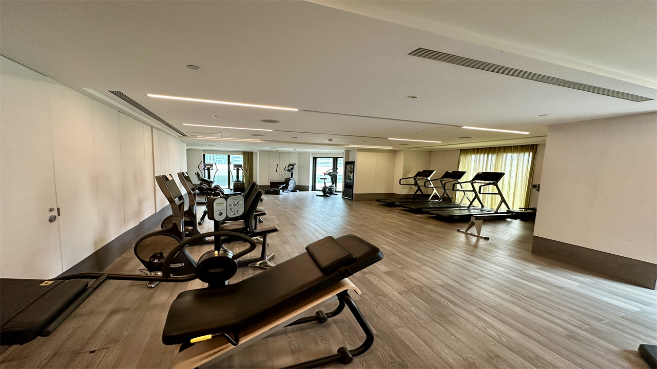 a room with exercise equipment and a wood floor at the Mandarin Oriental Taipei
