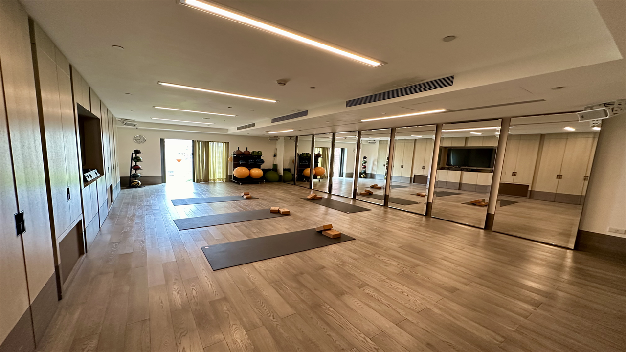a room with yoga mats and exercise balls