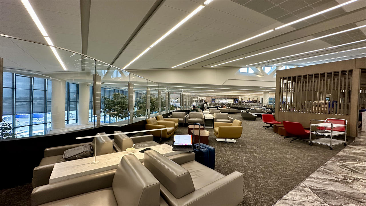 a lounge area with chairs and tables