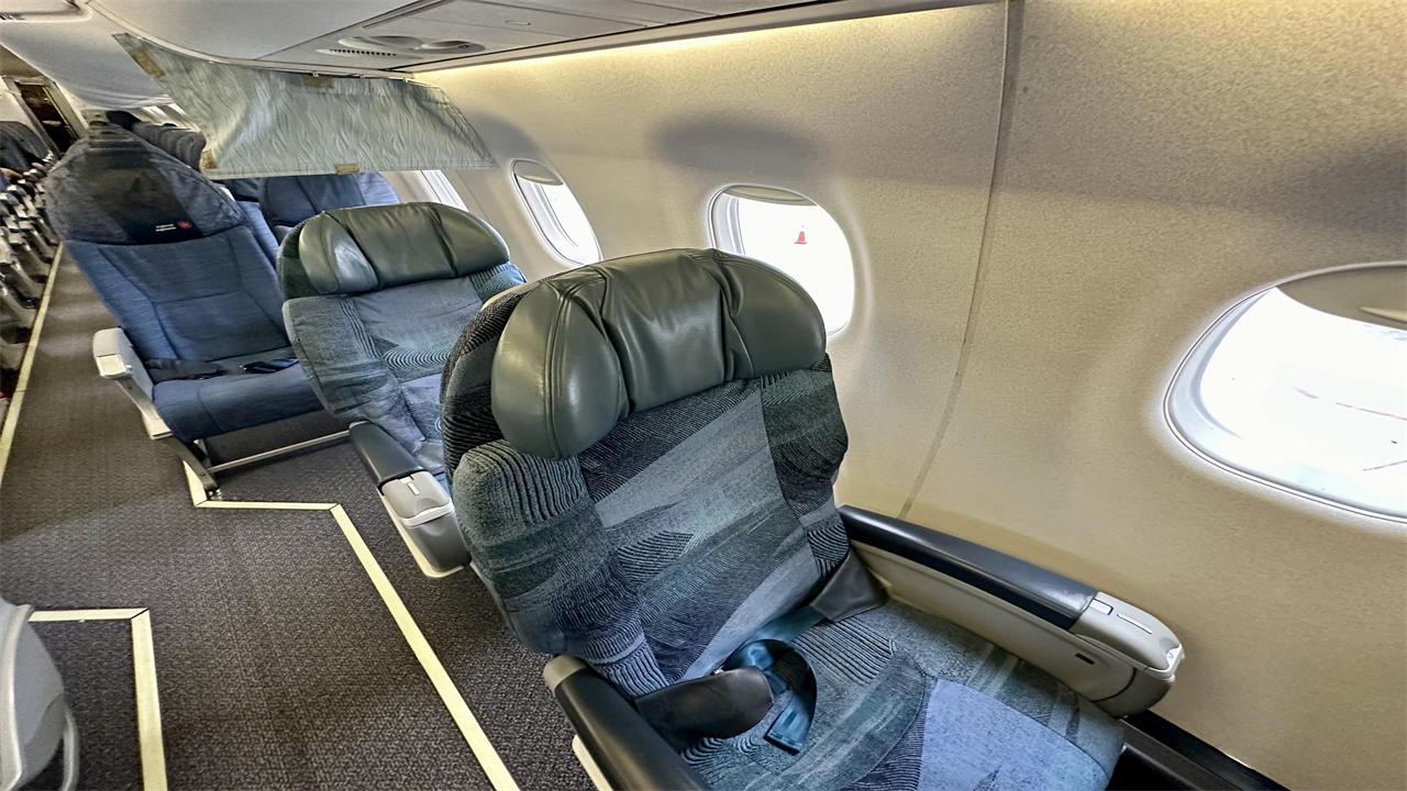 a row of seats on an Air Canada Jazz Business Class E175