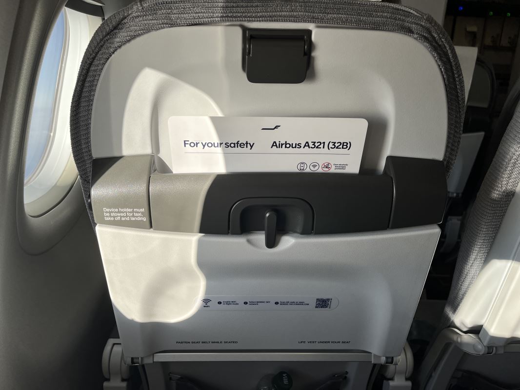 an airplane seat with an airplane seat and a card