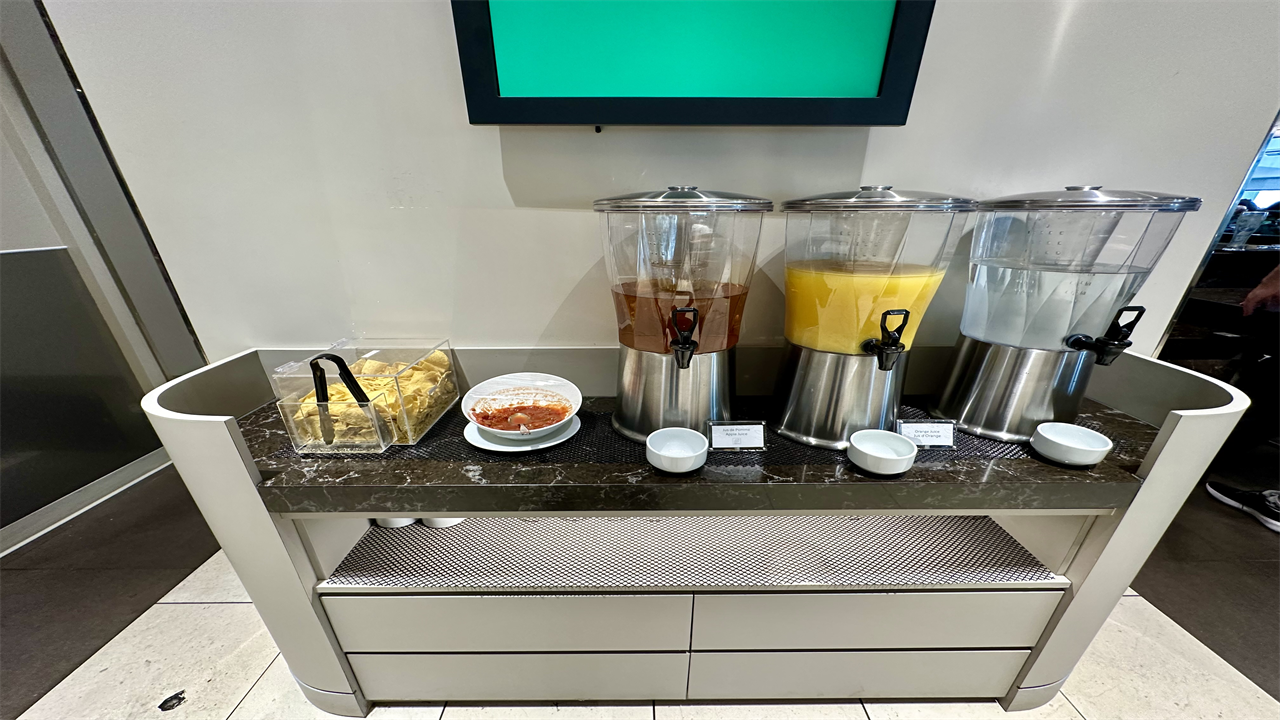 a group of juice dispensers on a counter