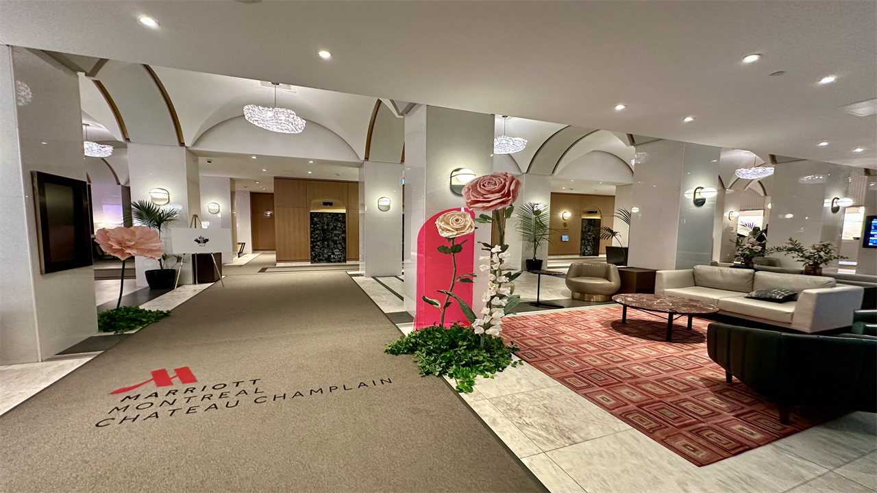 a lobby with a large pink and white flower display at Montreal Marriott Chateau Champlain