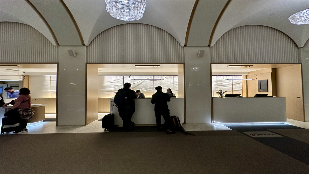 people standing at a reception desk