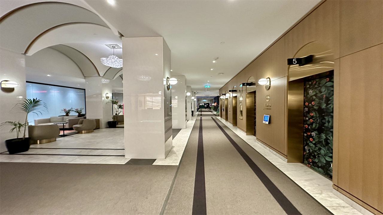 a hallway with elevators and chairs at the Montreal Marriott Chateau Champlain