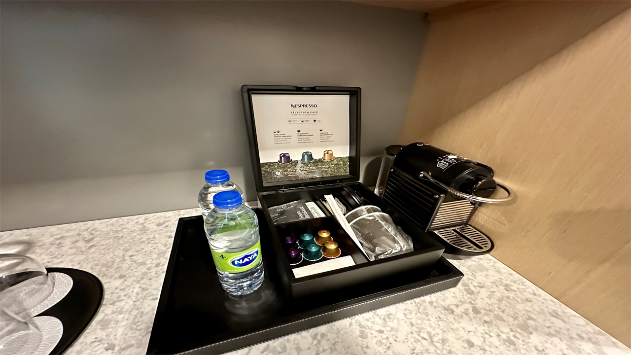 a coffee machine and a bottle of water on a table