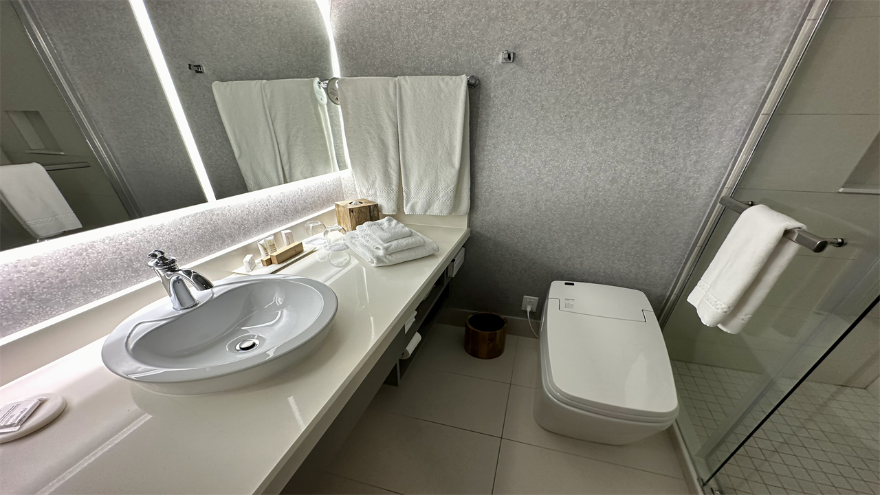 a bathroom with a sink toilet and mirror at the Montreal Marriott Chateau Champlain