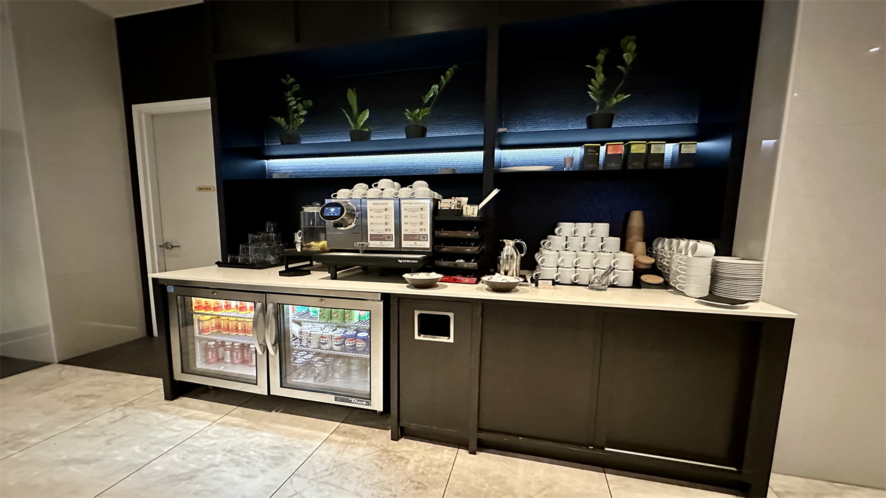 a coffee bar with a fridge and a drink cooler