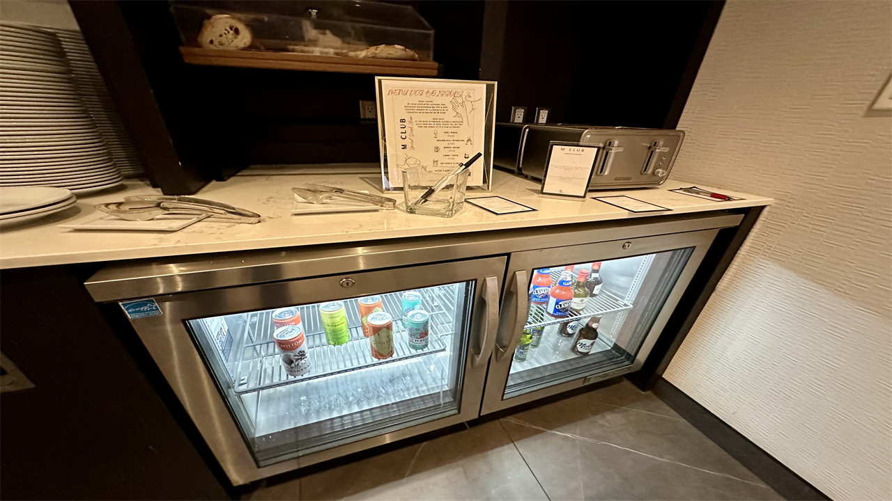 a refrigerator with drinks on top of it