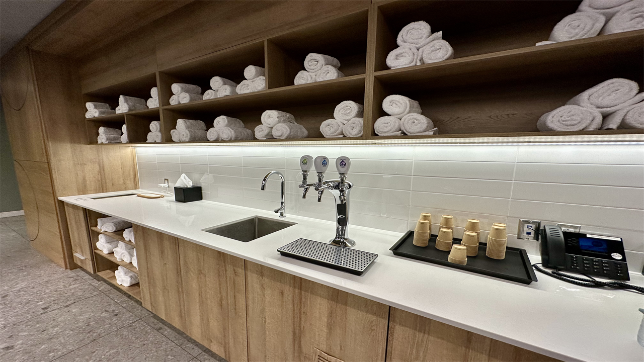 a counter with a sink and faucet and towels on it